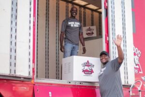 two friendly movers from Bulldog Movers loading a truck with boxes