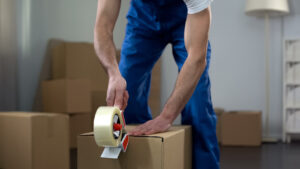 Person taping a box to prepare for moving